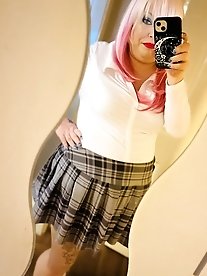 A blonde, curvaceous woman is undressing.